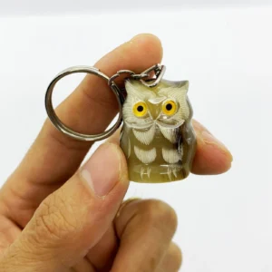 Buffalo horn owl keychain — hand-carved, natural horn streaks