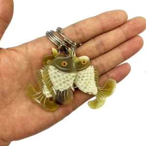 Buffalo horn fish keychain — three colour variants side by side