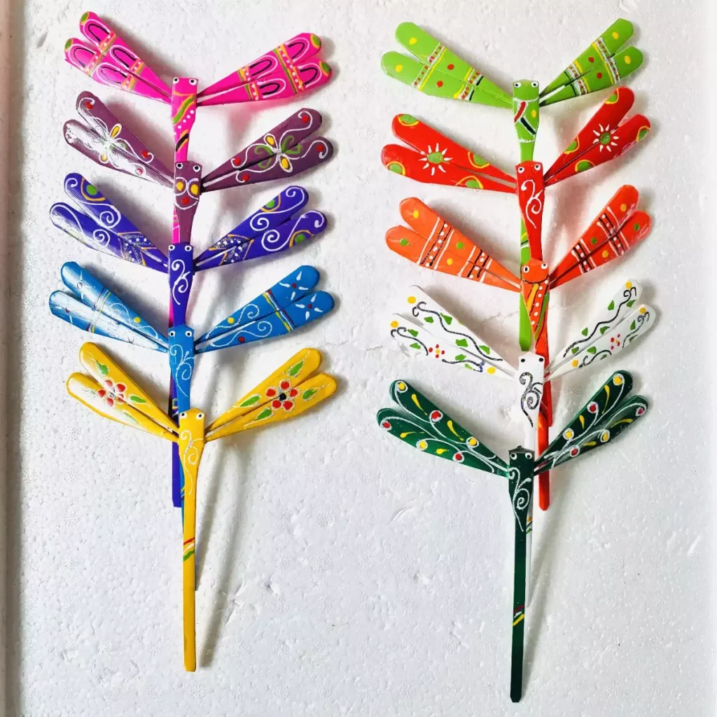 Two hand-painted bamboo dragonflies on a white background